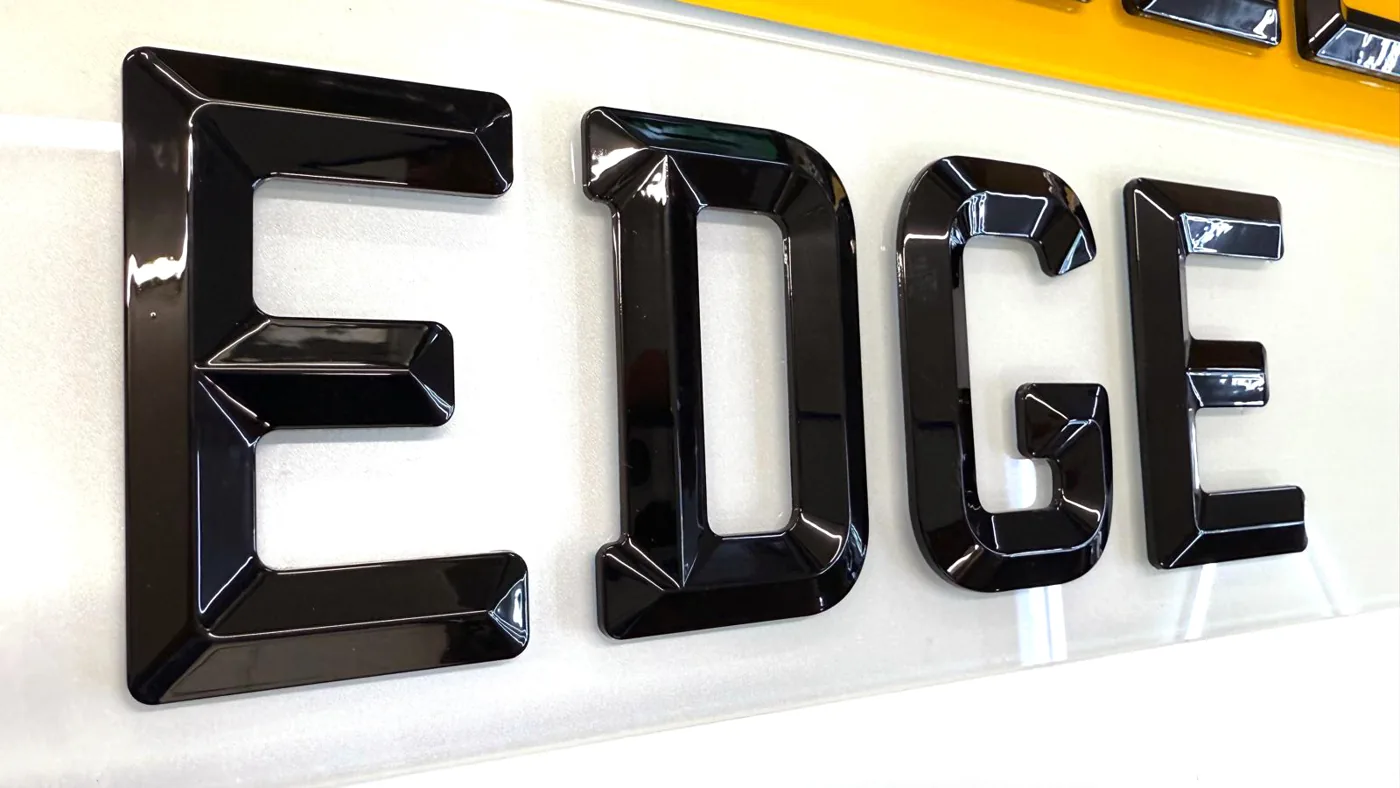 Side-angle close-up of 4D bevelled acrylic letters showing the chamfered edge profile